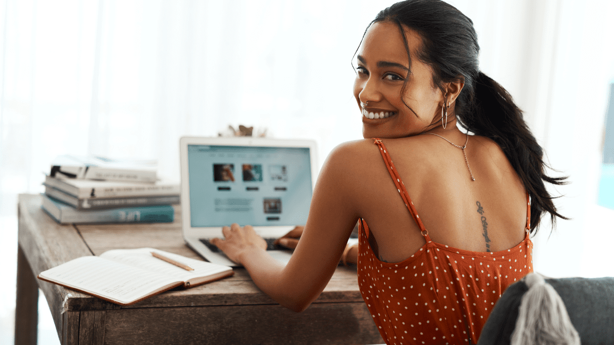 Nomade digital trabalhando em um laptop na praia, ilustrando como monetizar um blog de viagem e gerar renda.